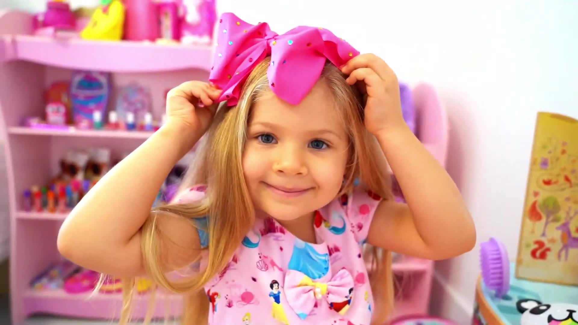 A cute little girl with long blonde hair is putting on a big, sparkly pink bow! Sheโs wearing a pink dress with fun cartoon patterns, and in the background, there are colorful toys and a pink play shelf. Itโs such a sweet, playful scene perfect for little ones! ๐โจ