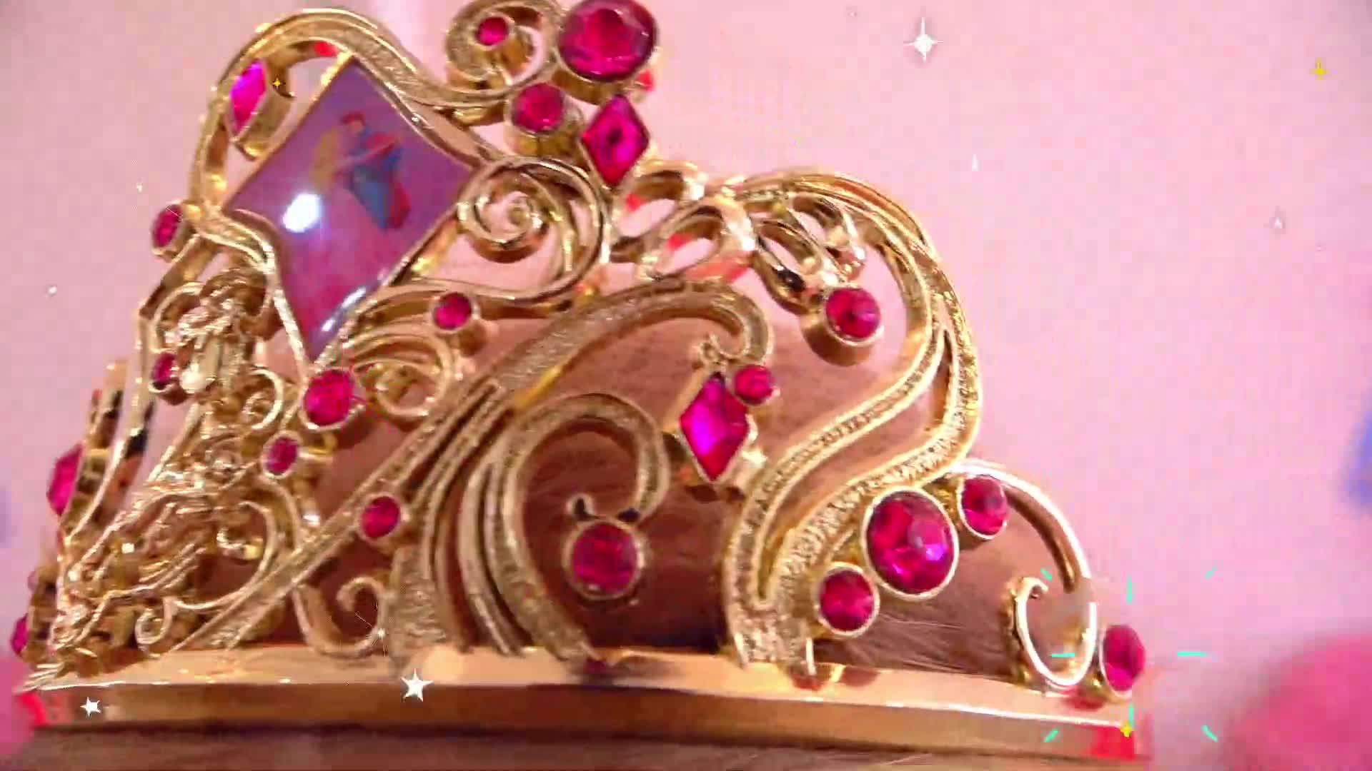 A magical golden tiara with shiny pink gemstones! It has pretty curly designs and a diamond-shaped center, perfect for little princesses' adventures! 💖✨