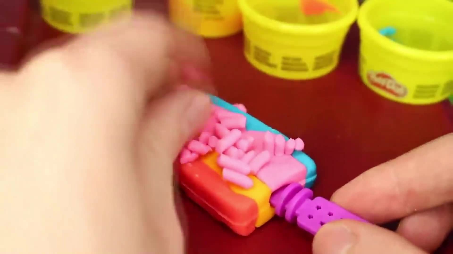 Watch me create a super cute Play-Doh project! I'm using bright, colorful clay—pink, blue, yellow, and more! With my hands, I'm building a fun little toy, squishing and shaping the clay into cool shapes. It's so easy and perfect for kids who love crafts and playtime! Let's get creative with Play-Doh today! 🎨🧩