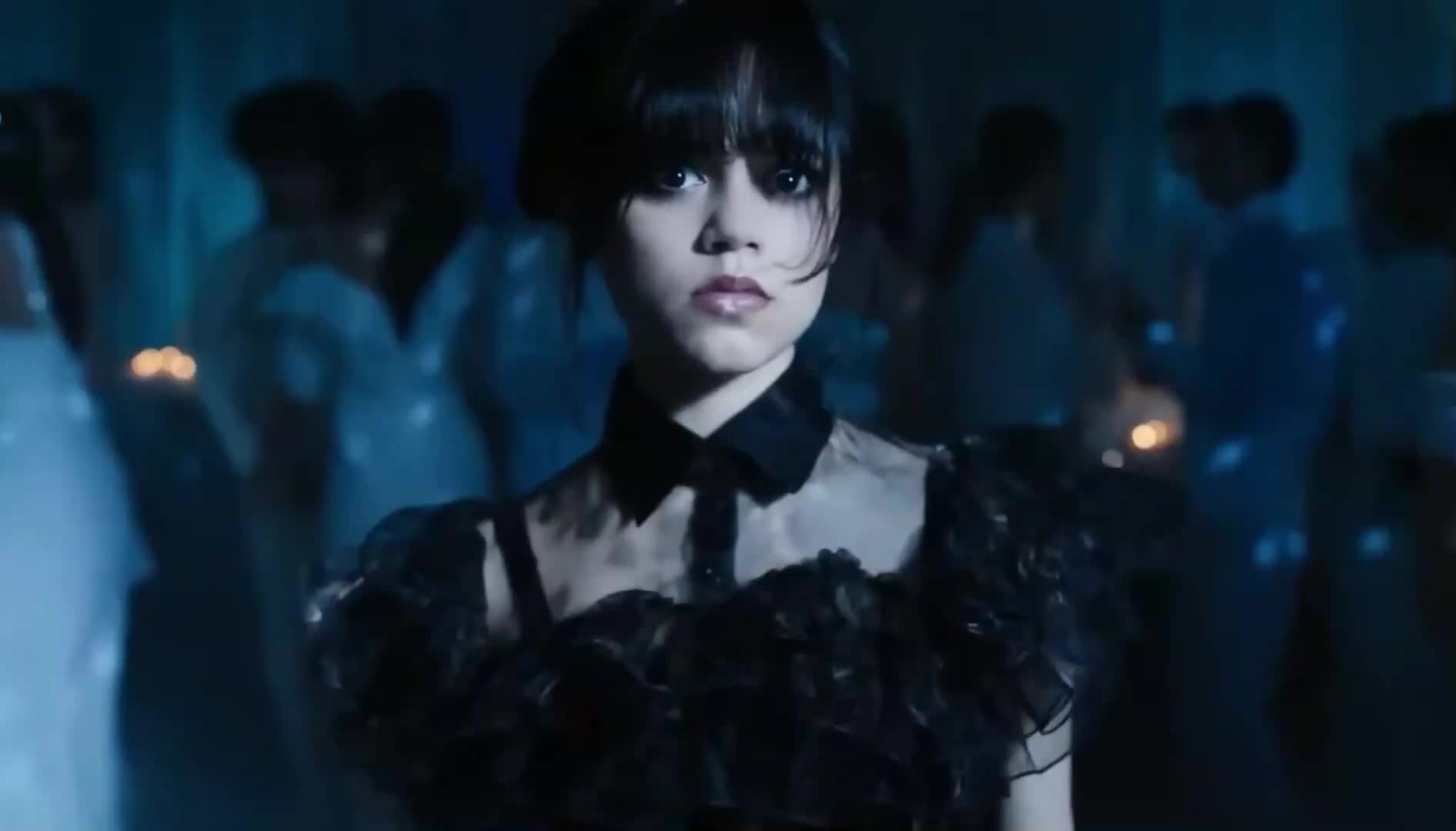 A young girl with dark hair and a black ruffled dress stands alone in a dimly lit ballroom, surrounded by softly glowing candles and shadowy figures. The air feels magical and slightly eerie as she moves to the unheard musicโperfect for little adventurers! ๐ถ๐