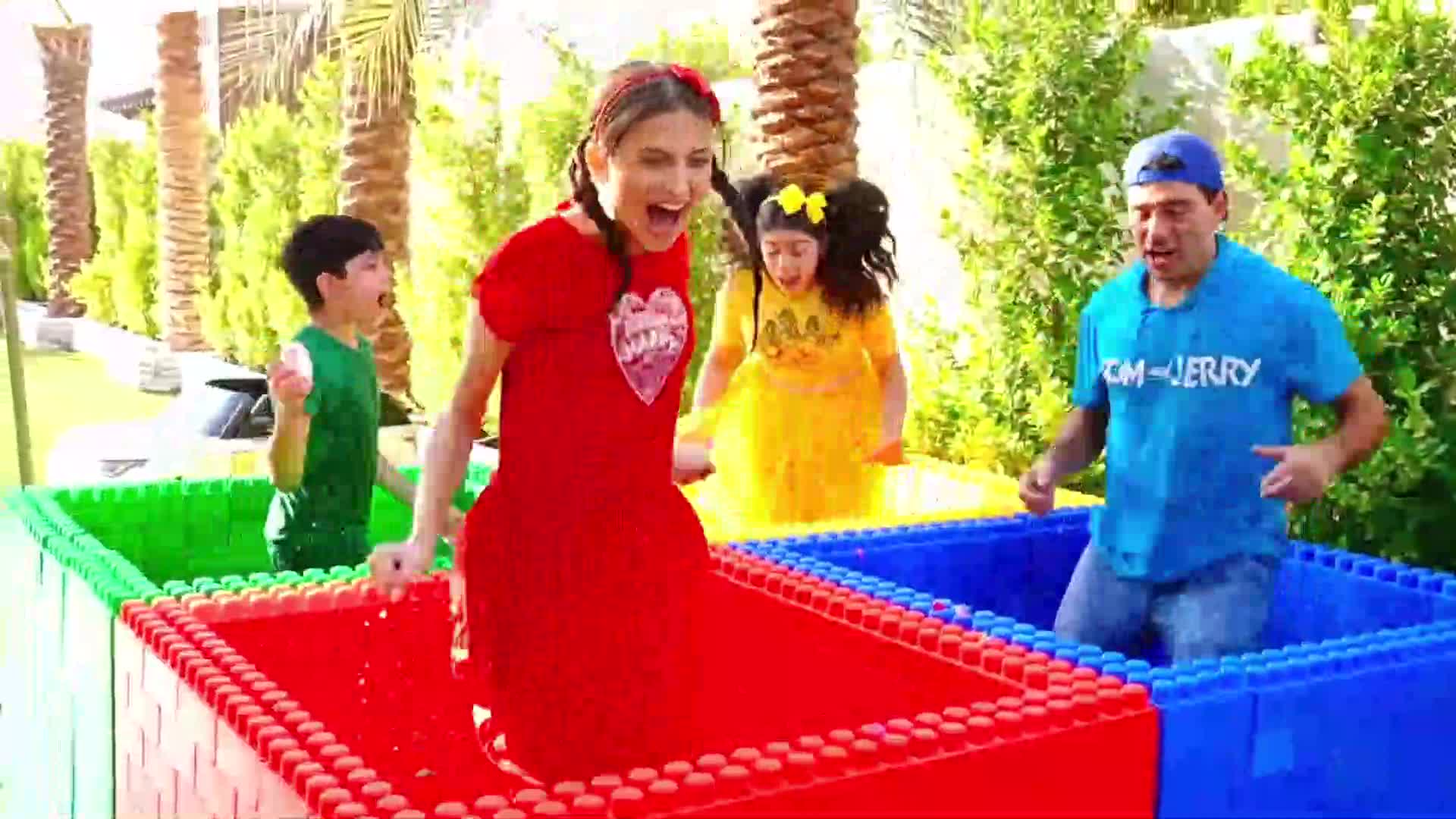 A group of kids and an adult are having a hilarious time in a colorful building block pool! They’re laughing, playing, and enjoying every moment together—such a fun, lively scene for little ones! 🎈💦 #KidsFun #BuildingBlocksAdventure