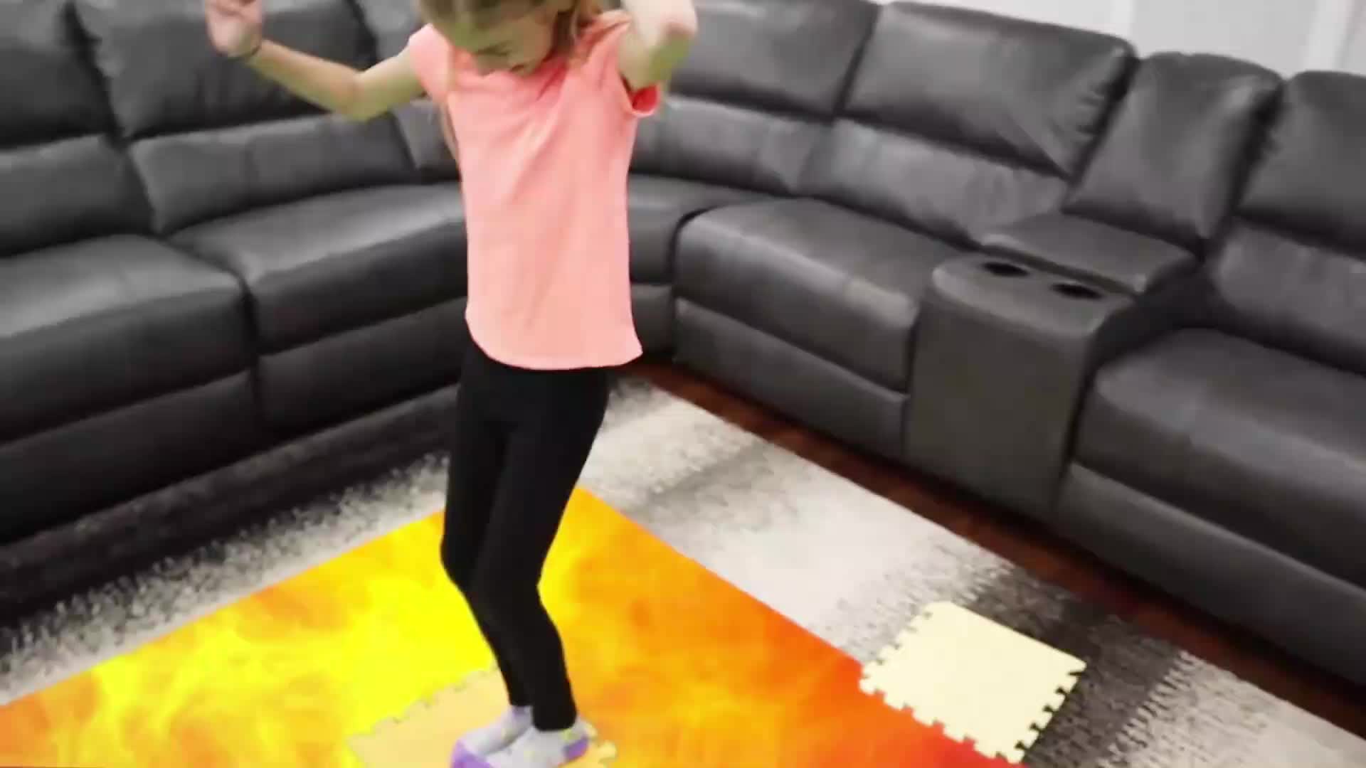 A cute little girl is having an amazing time jumping on her vibrant flame-patterned foam mat! ๐ She bounces and plays happily in the living room, with a cozy black corner couch nearby. It's a lively, playful video full of joyโperfect for kids who love active, colorful games! ๐ฎ๐งฉ