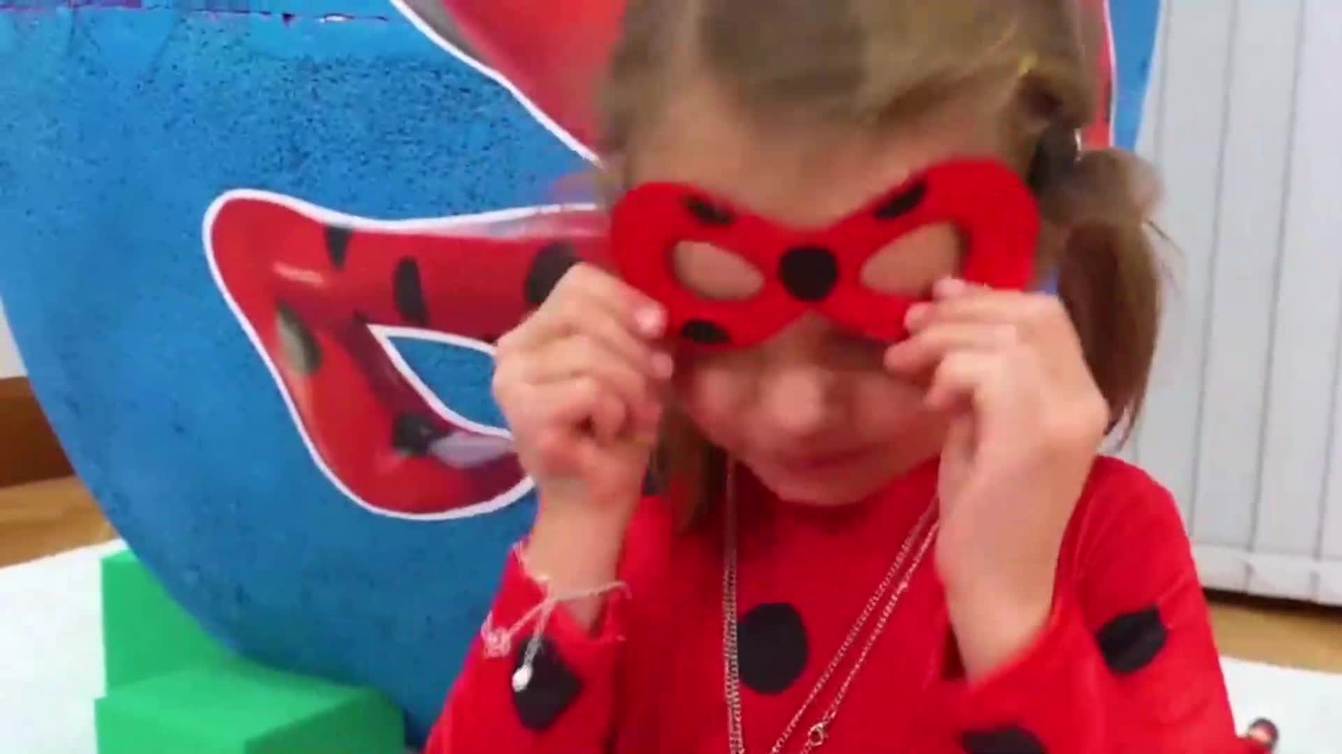 A cute little girl dressed up as Ladybug! She's trying on her red spotted mask, showing off her superhero costume, and having a blast playing pretend in this playful video! 🎭❤️