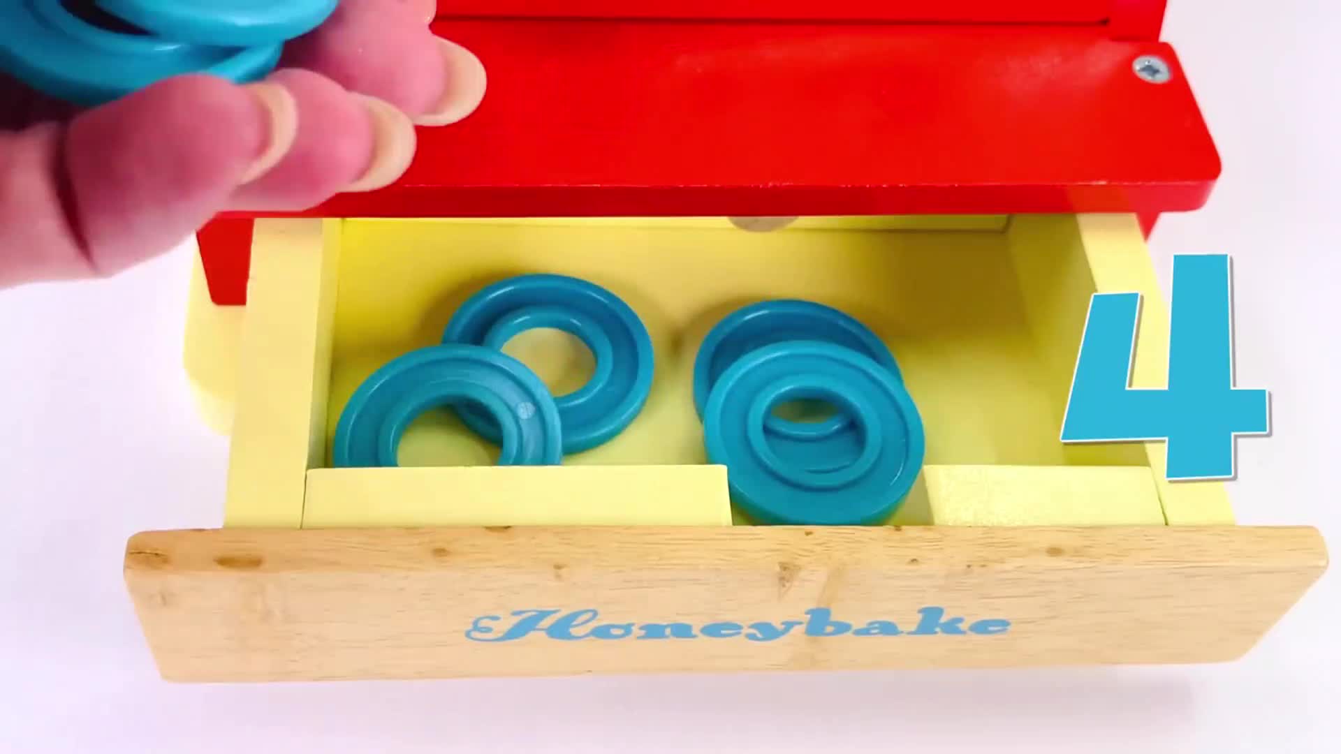 Watch this fun counting game with Honeybake's wooden drawer toy! See how we place blue rings into the drawer, counting as we go. Learn numbers, colors, and fine motor skills through play—perfect for little ones! 🎈✨