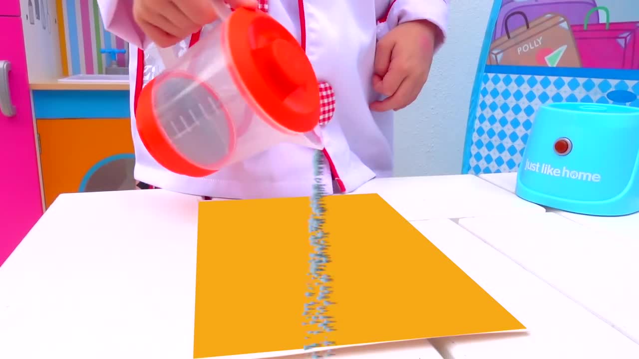 A tiny chef in a white coat is having so much fun pouring water on a bright yellow paper! Watch this playful kitchen experiment where learning and creativity mix—perfect for little ones who love to play and explore! 🎨✨