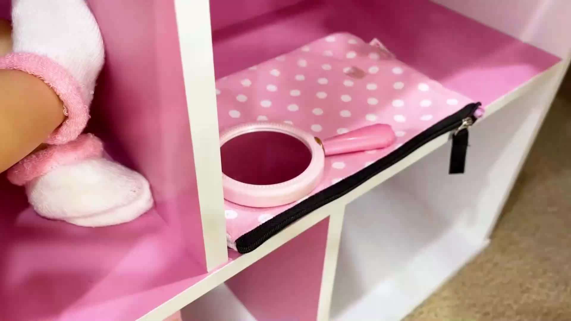 A tiny hand discovers a cute pink polka dot bag, a sparkly mirror, and a little comb hidden in a colorful dollhouse! So many sweet, playful treasures to explore in this cozy playtime corner. 💖🧸